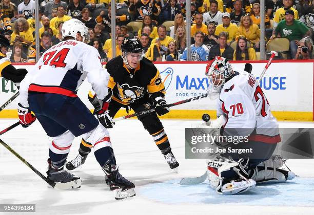 Braden Holtby of the Washington Capitals makes a save against Jake Guentzel of the Pittsburgh Penguins in Game Four of the Eastern Conference Second...