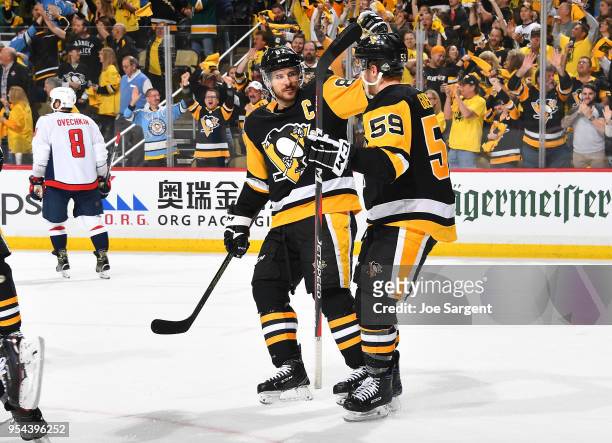 Jake Guentzel of the Pittsburgh Penguins celebrates with Sidney Crosby of the Pittsburgh Penguins after scoring in the third period against the...