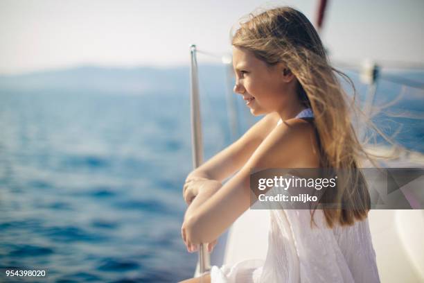 girl enjoying on yacht while sailing - miljko stock pictures, royalty-free photos & images