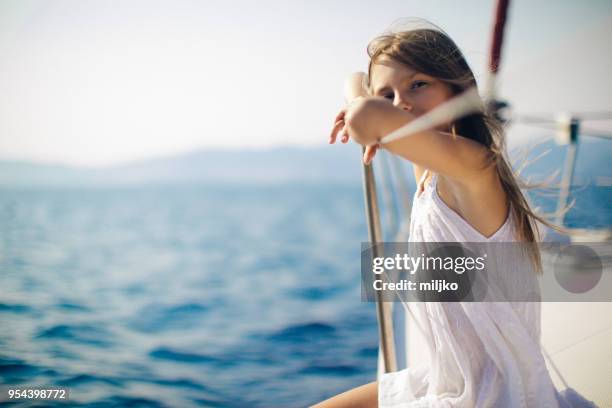 girl enjoying on yacht while sailing - miljko stock pictures, royalty-free photos & images