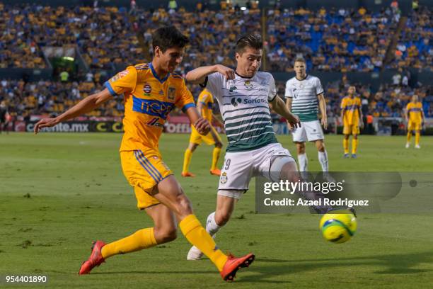 Jurgen Damm of Tigres fights for the ball with Jorge Villafana of Santos during the quarter finals first leg match between Tigres UANL and Santos...