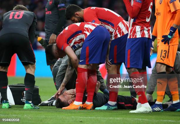 Laurent Koscielny of Arsenal is seriously injured during the UEFA Europa League Semi Final second leg match between Atletico Madrid and Arsenal FC at...