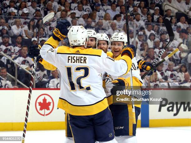 Mike Fisher, Ryan Hartman, Yannick Weber and Miikka Salomaki of the Nashville Predators celebrate a first period goal against the Winnipeg Jets in...