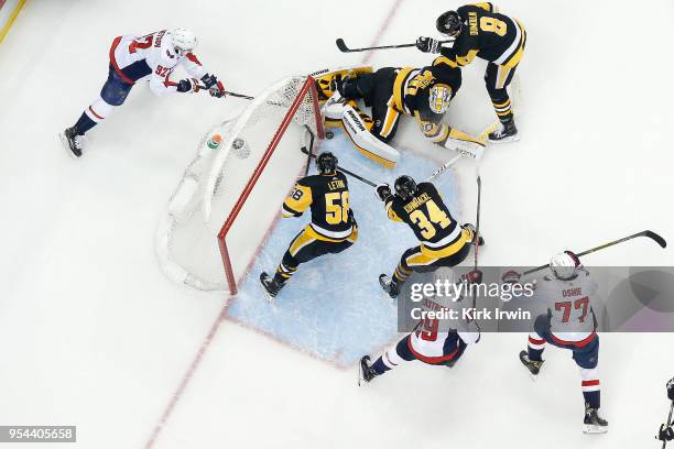 Matt Murray of the Pittsburgh Penguins keeps Evgeny Kuznetsov of the Washington Capitals from scoring a goal as Kris Letang and Tom Kuhnhackl of the...