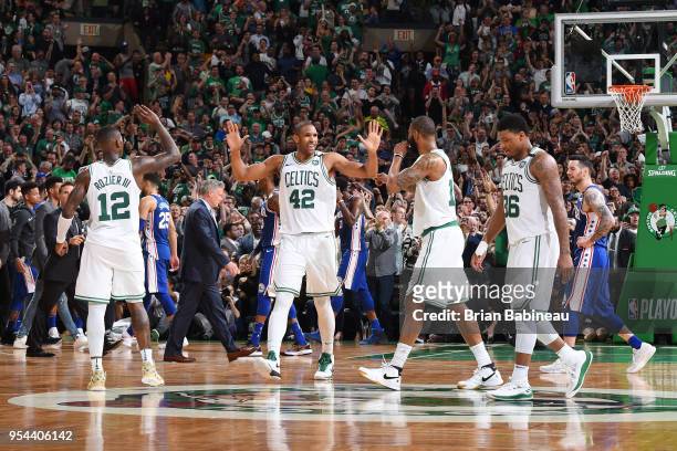 Al Horford of the Boston Celtics exchanges high fives with Terry Rozier and Marcus Morris against the Philadelphia 76ers in Game Two of Round Two of...
