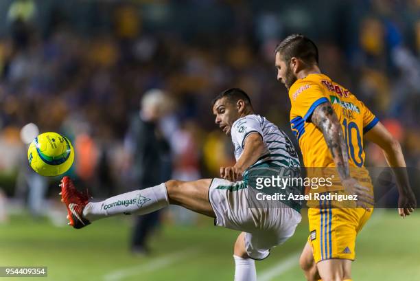 Andre-Pierre Gignac of Tigres fights for the ball with Gerardo Alcoba of Santos during the quarter finals first leg match between Tigres UANL and...