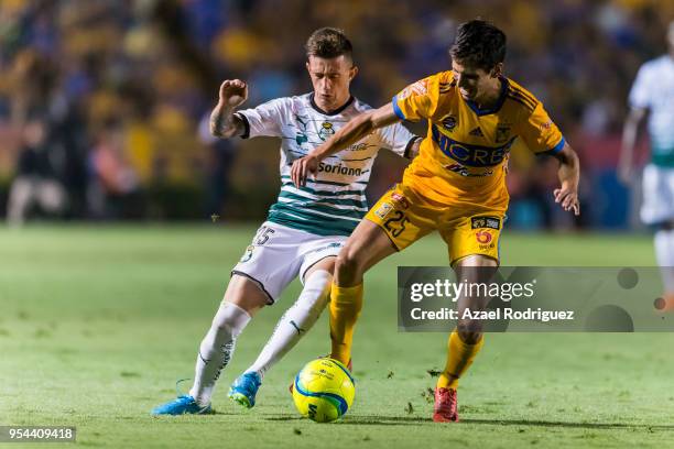 Jurgen Damm of Tigres fights for the ball with Brian Lozano of Santos during the quarter finals first leg match between Tigres UANL and Santos Laguna...