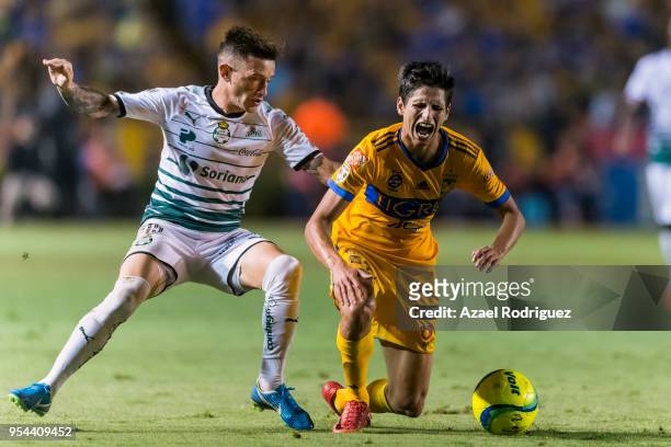 Jurgen Damm of Tigres fights for the ball with Brian Lozano of Santos during the quarter finals first leg match between Tigres UANL and Santos Laguna...