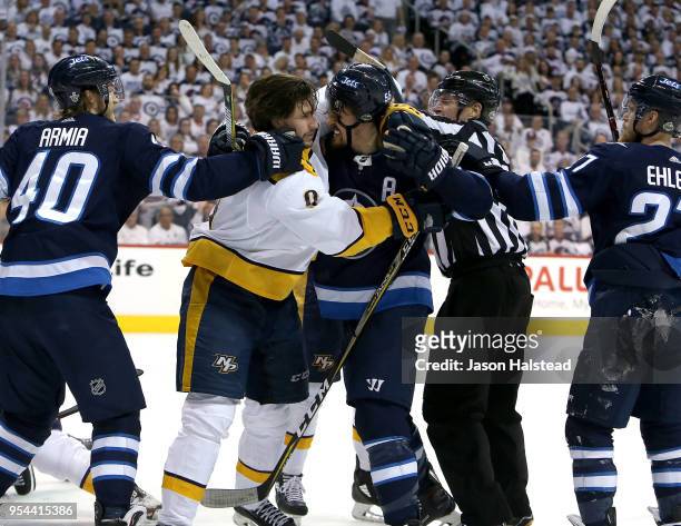 Filip Forsberg of the Nashville Predators battles with Mark Scheifele of the Winnipeg Jets in Game Four of the Western Conference Second Round during...