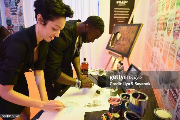 Aldis Hodge and Harmonia Rosales celebrate the national launch of Frontier Works: Bottle Impressions in the Bulleit Frontier Whiskey Lounge at Frieze...