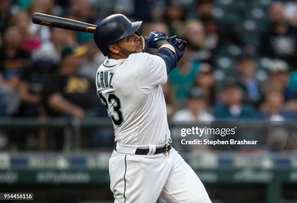 Nelson Cruz of the Seattle Mariners hits a three-run home run off of starting pitcher Sean Manaea of the Oakland Athletics during the third inning of...