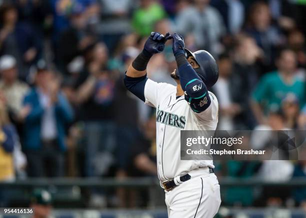 Nelson Cruz of the Seattle Mariners celebrates after hitting a two-run home run off of starting pitcher Sean Manaea of the Oakland Athletics during...