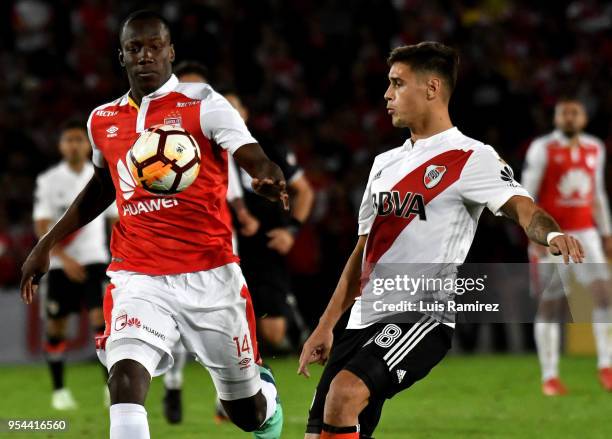 Baldomero Perlaza of Santa Fe vies for the ball with Lucas Martinez Quarta of River Plate during a group stage match between Independiente Santa Fe...