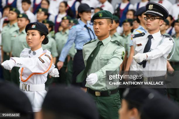 Member of the Hong Kong Army Cadets Association , set up in 2015, uses the PLA quick march as he takes part in an annual flag raising ceremony in...