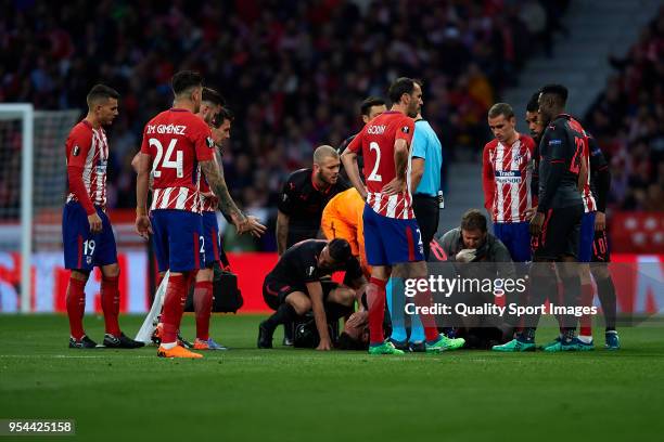 Laurent Koscielny of Arsenal FC lies injured on the pitch during the UEFA Europa League Semi Final second leg match between Atletico Madrid and...