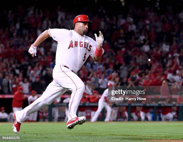 Albert Pujols of the Los Angeles Angels runs as he hits a double for his 2999th career hit during the second inning against the Baltimore Orioles at...