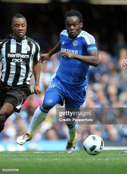 Michael Essien of Chelsea and Kazenga LuaLua of Newcastle in action during the Barclays Premier League match between Chelsea and Newcastle United at...