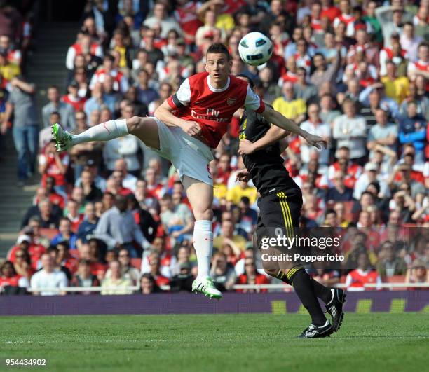 Laurent Koscielny of Arsenal and Andy Carroll of Liverpool in action during the Barclays Premier League match between Arsenal and Liverpool at the...