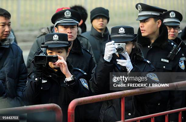 Beijing police video and photograph journalists during the trial of leading Chinese dissident Liu Xiaobao on subversion charges on December 23, 2009...