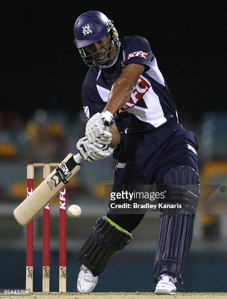 Ross Taylor of the Bushrangers drives the ball over the boundary for a six during the Twenty20 Big Bash match between the Queensland Bulls and the...