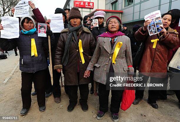 Wearing yellow ribbons in support of leading Chinese dissident Liu Xiaobao, petitioners protest their personal gripes during Liu's trial on...