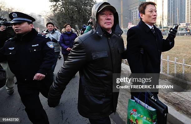 Shang Baojun , the lawyer for leading Chinese dissident Liu Xiaobao, is manhandled by plainclothes security personnel trying to keep him away from...