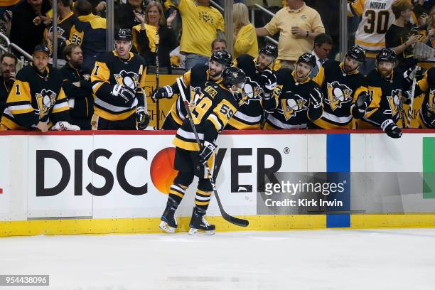 Jake Guentzel of the Pittsburgh Penguins is congratulated by his teammates after scoring a goal in Game Three of the Eastern Conference Second Round...