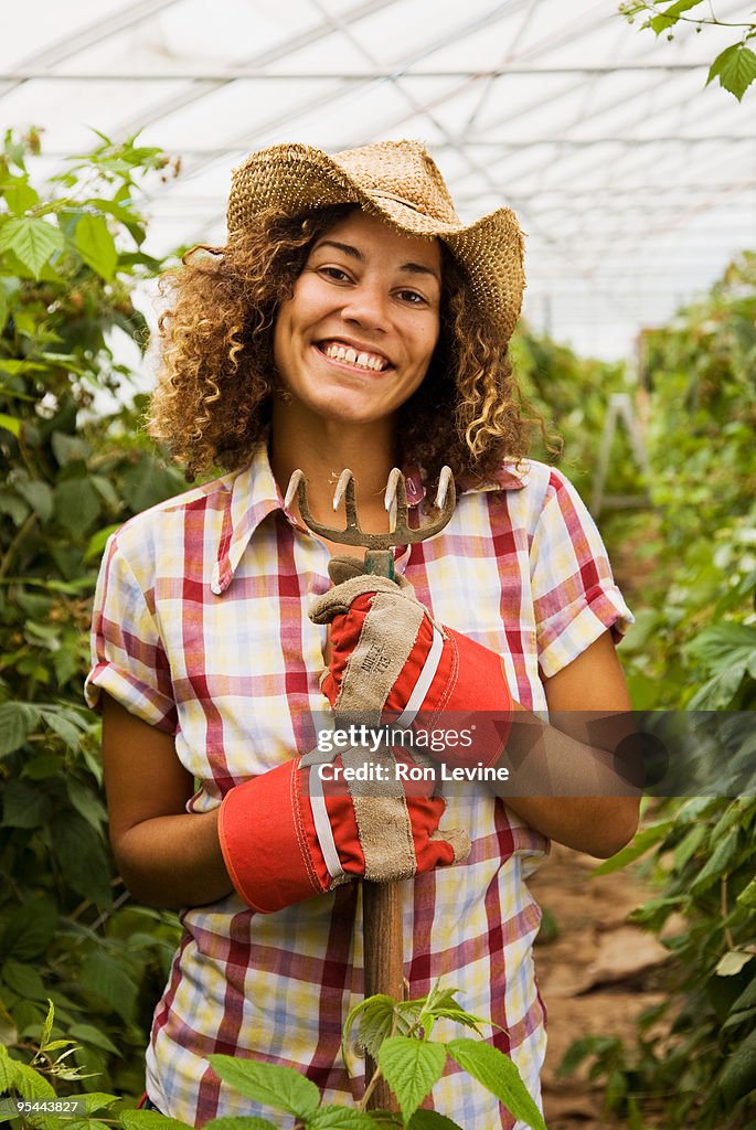 Female farm worker in a greenhouse, portrait