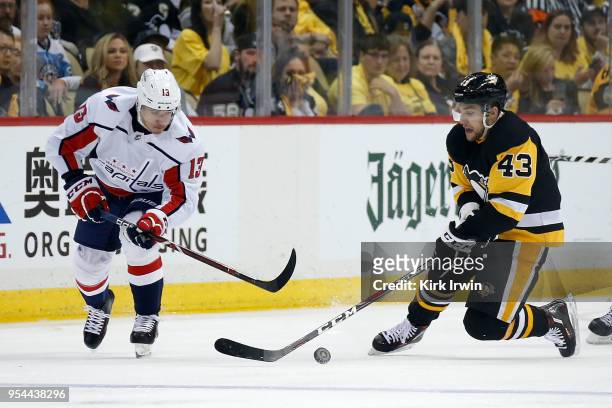 Jakub Vrana of the Washington Capitals and Conor Sheary of the Pittsburgh Penguins chase after the puck in Game Three of the Eastern Conference...