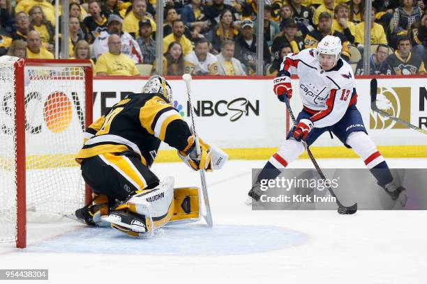 Jakub Vrana of the Washington Capitals attempts to get a shot off on Matt Murray of the Pittsburgh Penguins in Game Three of the Eastern Conference...