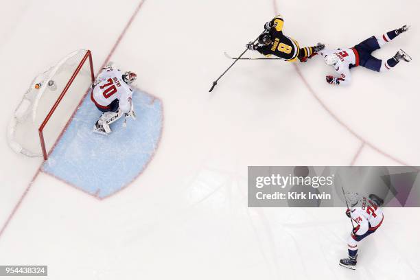 Michal Kempny of the Washington Capitals dives in an attempt to keep Brian Dumoulin of the Pittsburgh Penguins from getting a shot off on Braden...