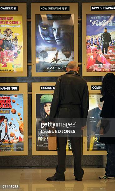 Man stands before posters advertising films including "Avatar", in Hong kong on December 28, 2009. It may boast ground-breaking 3D effects, but...