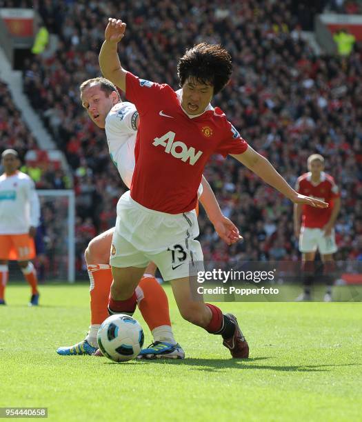 Ji-Sung Park of Manchester United is tackled by Charlie Adam of Blackpool during the Barclays Premier League match between Manchester United and...