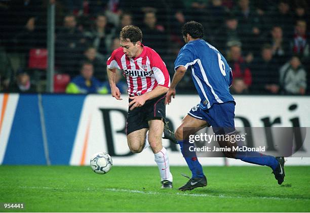 Georgi Gakhokidze of PSV Eindhoven takes the ball past Hany Ramzy of Kaiserslautern during the UEFA Cup Quarter Finals second leg match played at the...