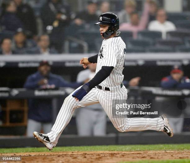 Gleyber Torres of the New York Yankees scores on a sacrifice fly by Aaron Judge in an MLB baseball game against the Minnesota Twins on April 25, 2018...