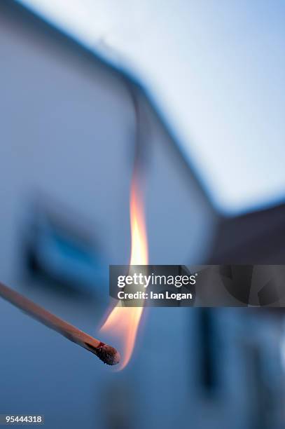 lit match in front of house - arson stock pictures, royalty-free photos & images