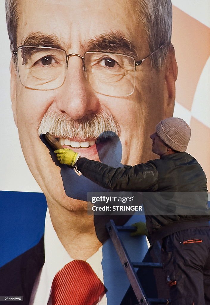 A worker puts up a poster of the ruling