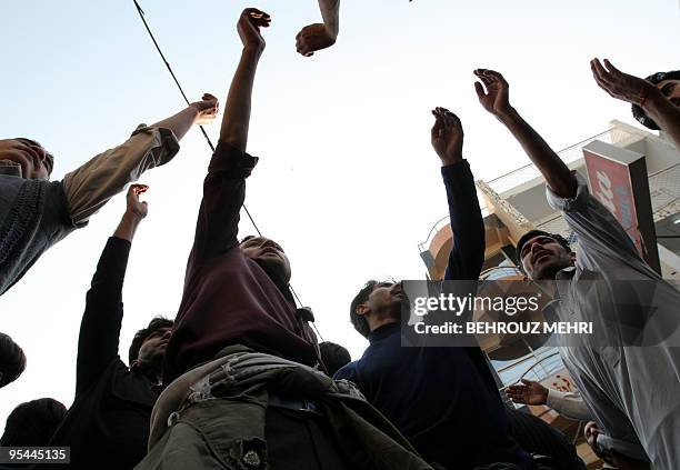 Pakistani Shiite Muslims beat their chests during a religious procession on the Ashura day of the holy Islamic month of Muharram at Raja Bazaar in...