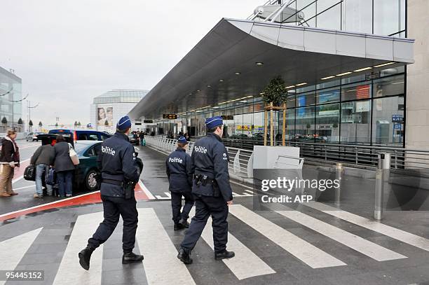 Belgian police officers are on duty at the Brussels Airport terminal, in Zaventem, on December 28, 2009. Security at airports around the world has...