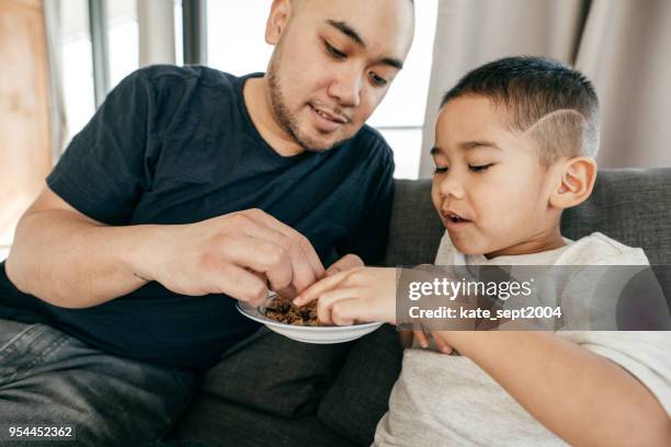 fatherhood - filipino family eating stock pictures, royalty-free photos & images