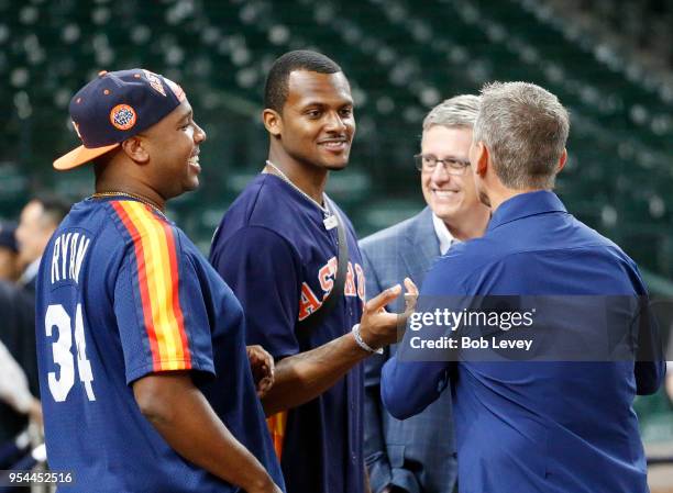 DeShaun Watson, center, talks with Jeff Luhnow, Houston Astros general manager and Craig Biggio at Minute Maid Park on May 1, 2018 in Houston, Texas.