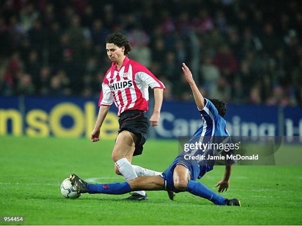 John De Jong of PSV Eindhoven takes the ball past Hany Ramzy of Kaiserslautern during the UEFA Cup Quarter Finals second leg match played at the...