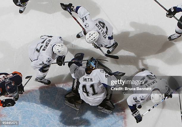 Mike Smith of the Tampa Bay Lightning makes the save against the New York Islanders at the Nassau Coliseum on December 21, 2009 in Uniondale, New...