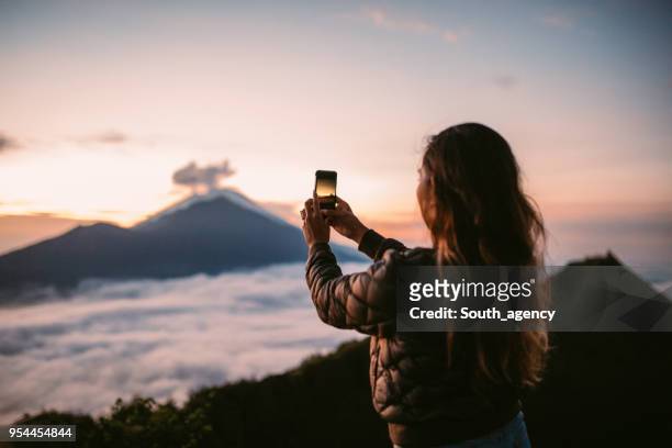 photographing sunset - bali volcano stock pictures, royalty-free photos & images