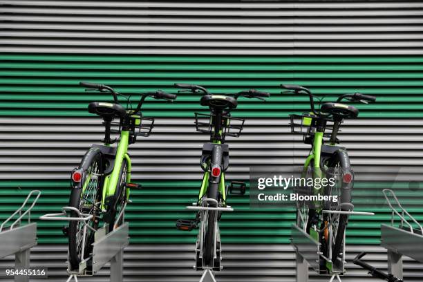 Anywheel hire bicycles sit on racks at a sidewalk in Singapore, on Thursday, April 26, 2018. Ride-hailing service Grab started a new app in March...