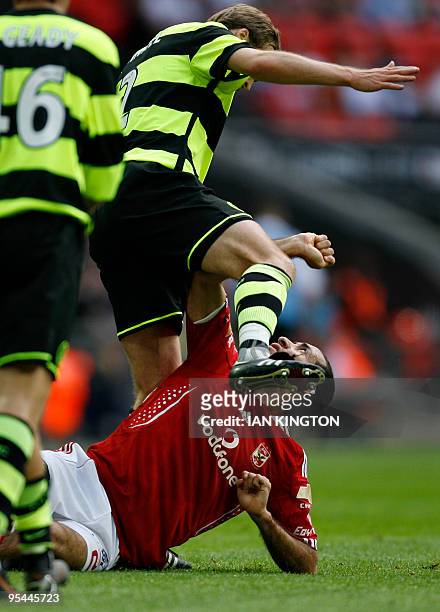 Al Ahly's Mohamed Aboutrika tangles with Celtic's German player Andreas Hinkel after a challenge during the Wembley Cup competition at Wembley...