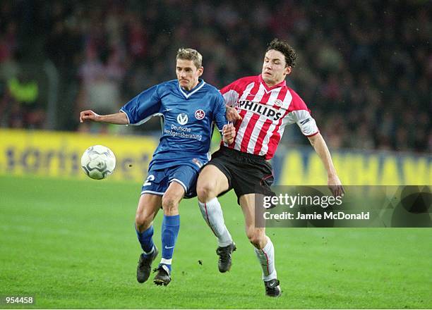 Andreas Buck of Kaiserslautern holds off Mark Van Bommel of PSV Eindhoven during the UEFA Cup Quarter Finals second leg match played at the Philips...