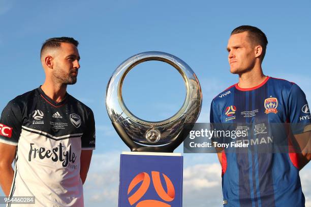 Carl Valeri of Melbourne Victory and Nigel Boogaard of the Jets pose with the Hyundai A-League Champions Trophy at the Newcastle waterfront during a...