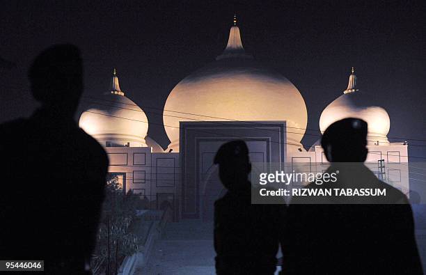 Pakistani policemen stand guard in front of the mausoleum of slain former Pakistani premier Benazir Bhutto on her second death anniversary in Garhi...