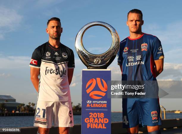 Carl Valeri of Melbourne Victory and Nigel Boogaard of the Jets pose with the Hyundai A-League Champions Trophy at the Newcastle waterfront during a...